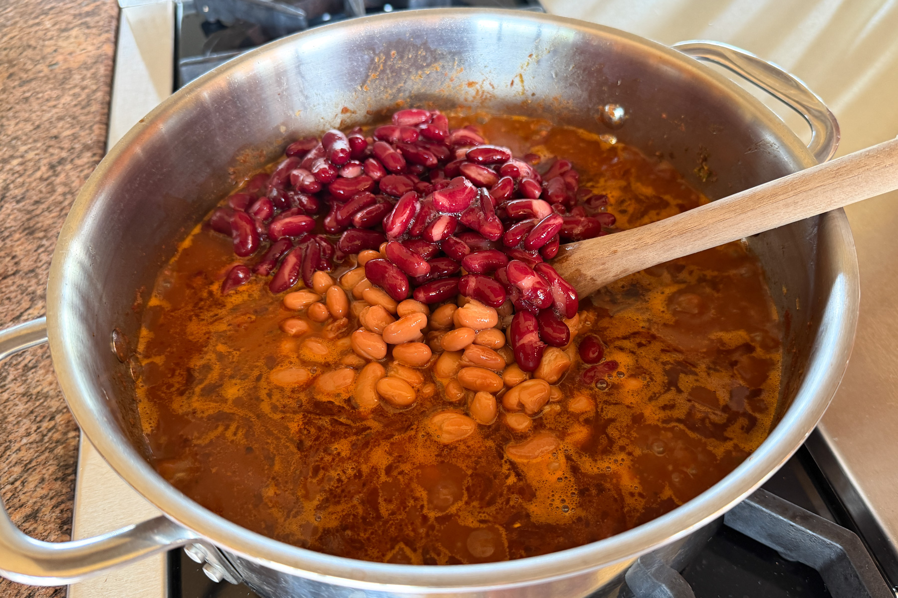 Making Zippy's chili. adding broth and beans.